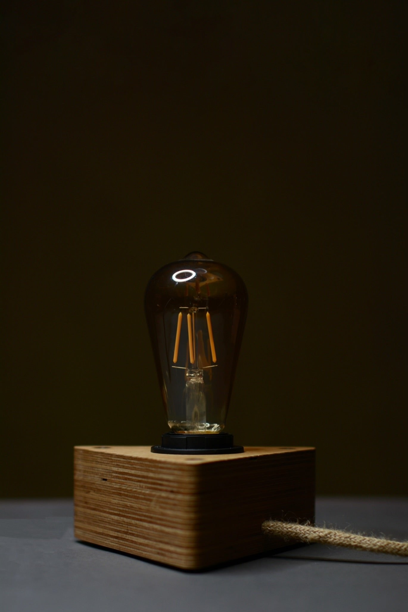 Handcrafted wooden table lamp made from beech, perfect for modern interiors. Lesena svetilka.